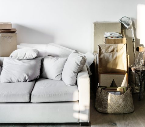 Disorganized living room with packed boxes and furniture for professional removals in Melbourne.