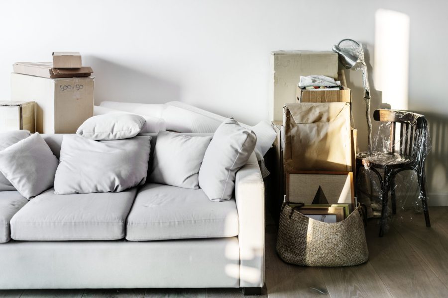 Disorganized living room with packed boxes and furniture for professional removals in Melbourne.